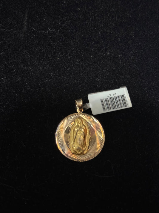 This image displays a striking gold-tone pendant featuring the image of the Virgin Mary. The circular pendant is elegantly designed with a detailed depiction of the virgin within a textured frame, enhancing its visual appeal.